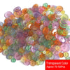 A pile of assorted transparent resin sewing buttons in various colors like pink, green, yellow, and purple.