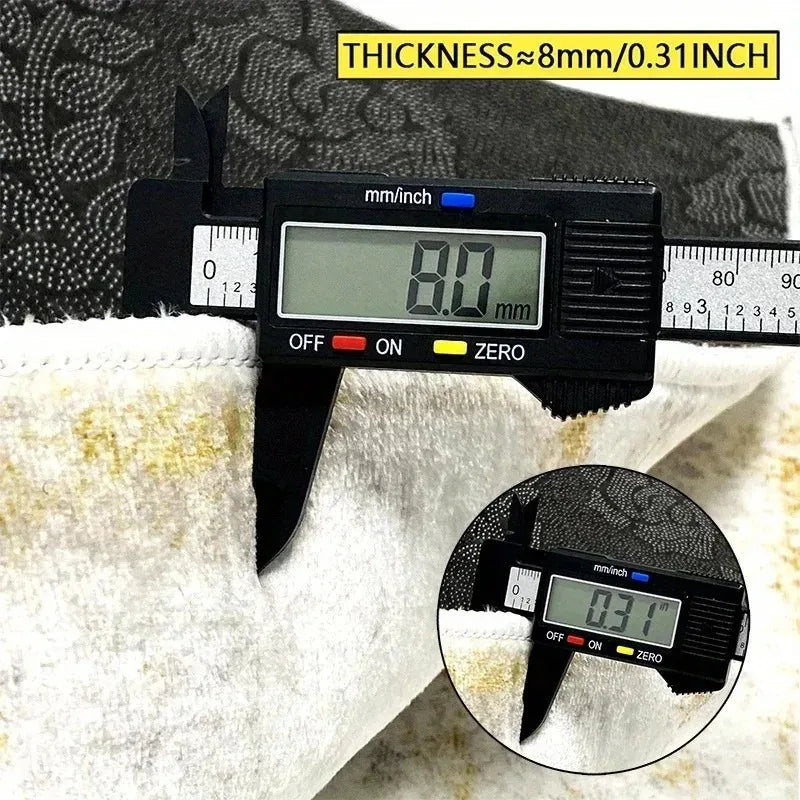 A digital thickness gauge measures 8.0 mm on a white towel, showing the measurement in millimeters and inches.