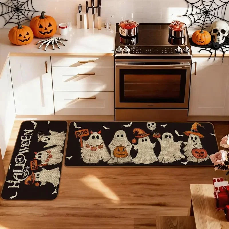 A set of Halloween ghost and pumpkin print non-slip kitchen rugs displayed on a wooden floor.