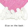 White embroidered cheer letter iron-on patch shown next to a pink ruler.