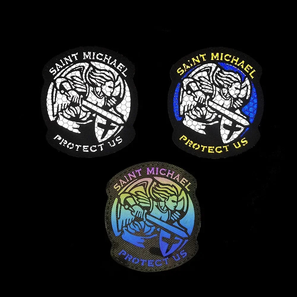 Three embroidered angel patches featuring a warrior figure and text on black and blue backgrounds.
