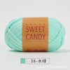 A ball of light mint green yarn labeled Sweet Candy with Chinese characters and a product code.