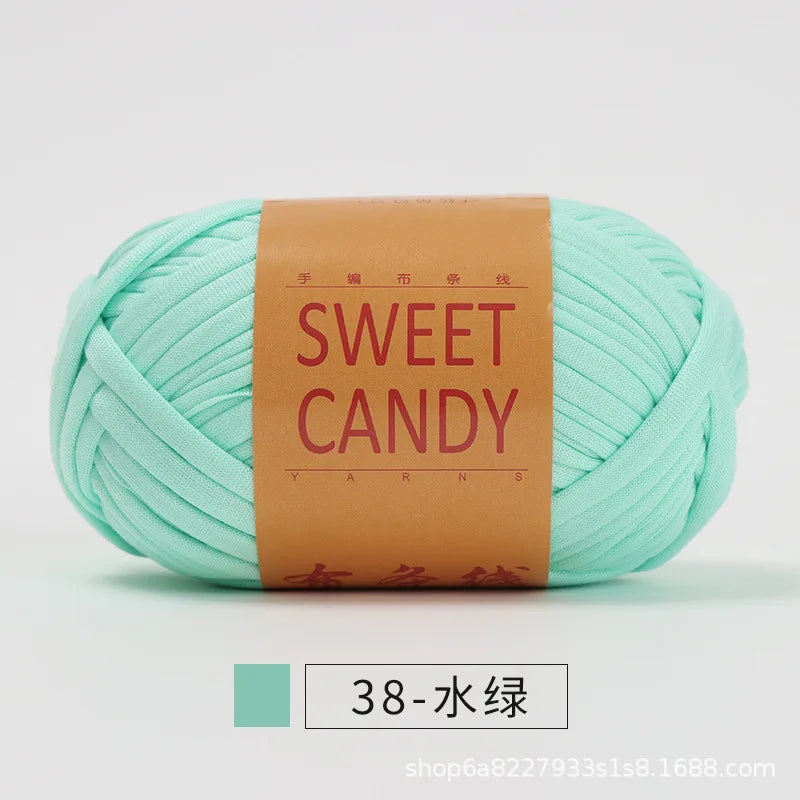 A ball of light mint green yarn labeled Sweet Candy with Chinese characters and a product code.