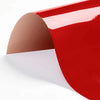 A sheet of red and beige heat transfer vinyl material shown in a curved, glossy form.