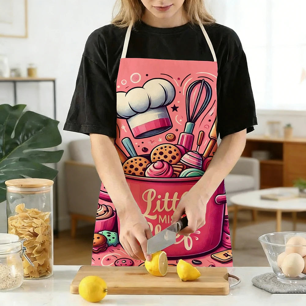 A woman wearing a pink kitchen apron with a baking design is holding a knife over a lemon on a wooden board.