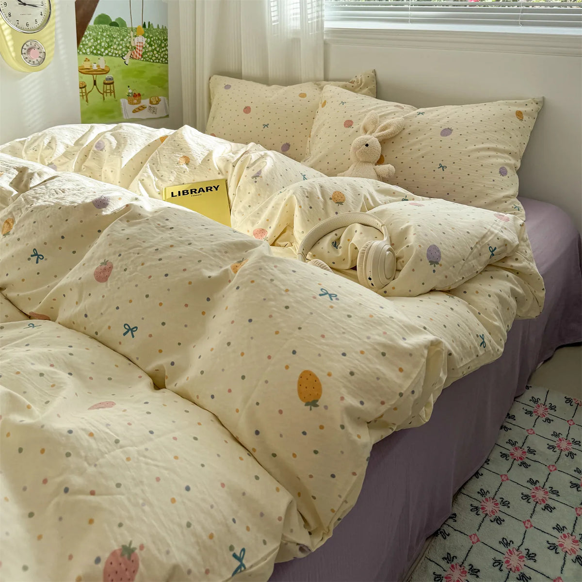 A light yellow floral microfiber duvet set with a patterned cover and a small stuffed rabbit toy on a bed.