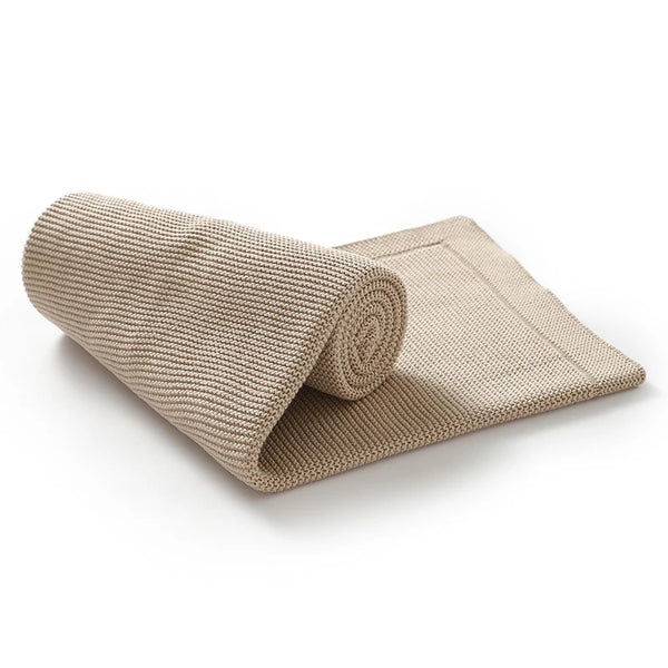 A rolled beige cotton baby swaddle blanket displayed on a white background.
