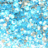 A pile of clear blue and silver glass rhinestones for DIY crafts
