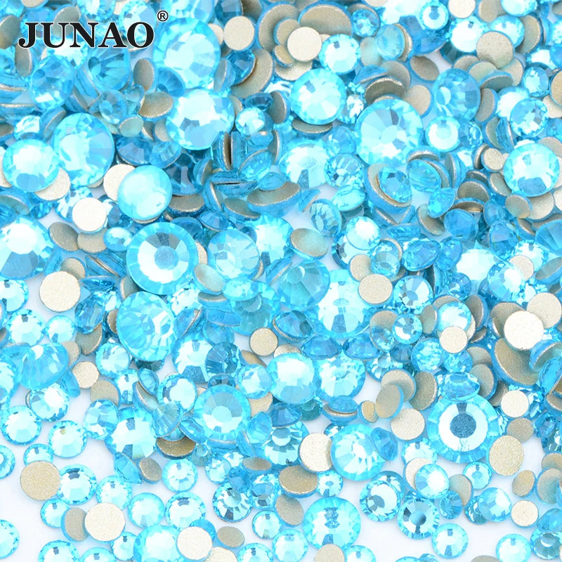 A pile of clear blue and silver glass rhinestones for DIY crafts