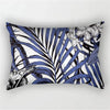 A decorative pillowcase featuring a black and blue tropical leaf print design.