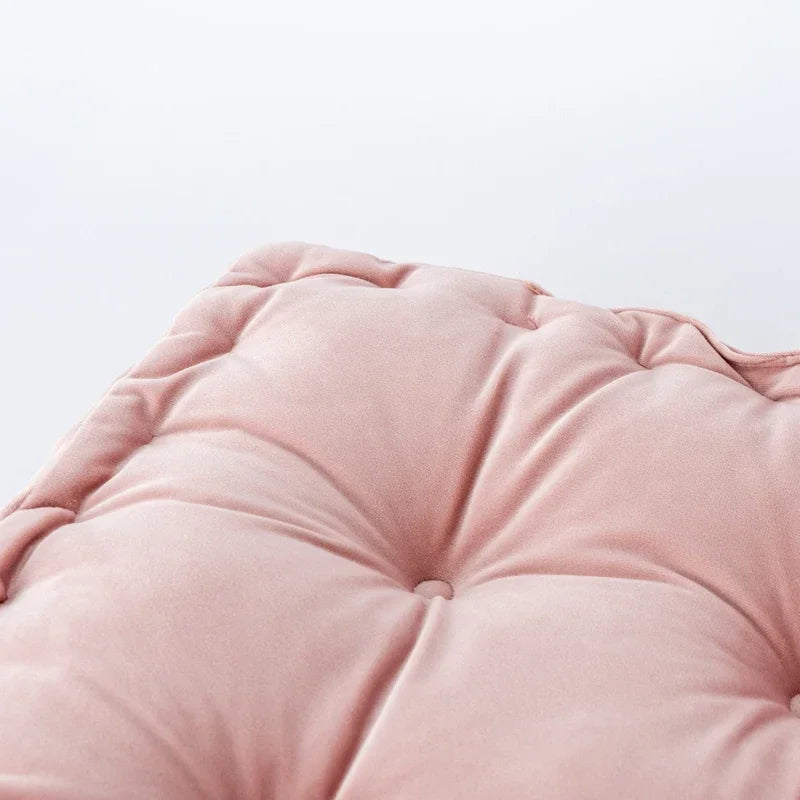 A soft pink square cotton throw pillow with quilted texture shown in a close-up view.