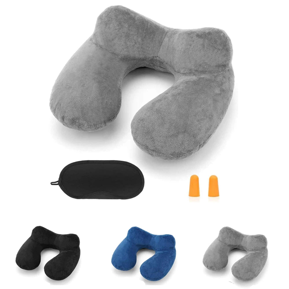 A collection of inflatable travel pillows in various shades of gray and blue, including a large gray pillow and smaller color