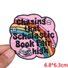 Pink embroidered patch with the slogan Chasing that Scholastic Book Fair high