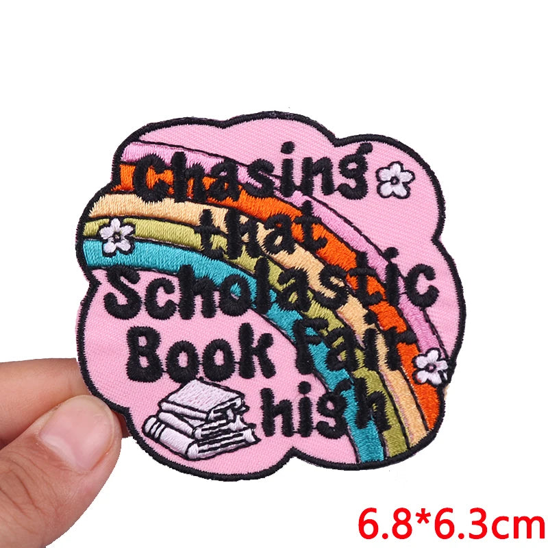 Pink embroidered patch with the slogan Chasing that Scholastic Book Fair high