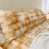 A fluffy, golden-brown plush long pillowcase resting on a light-colored surface.