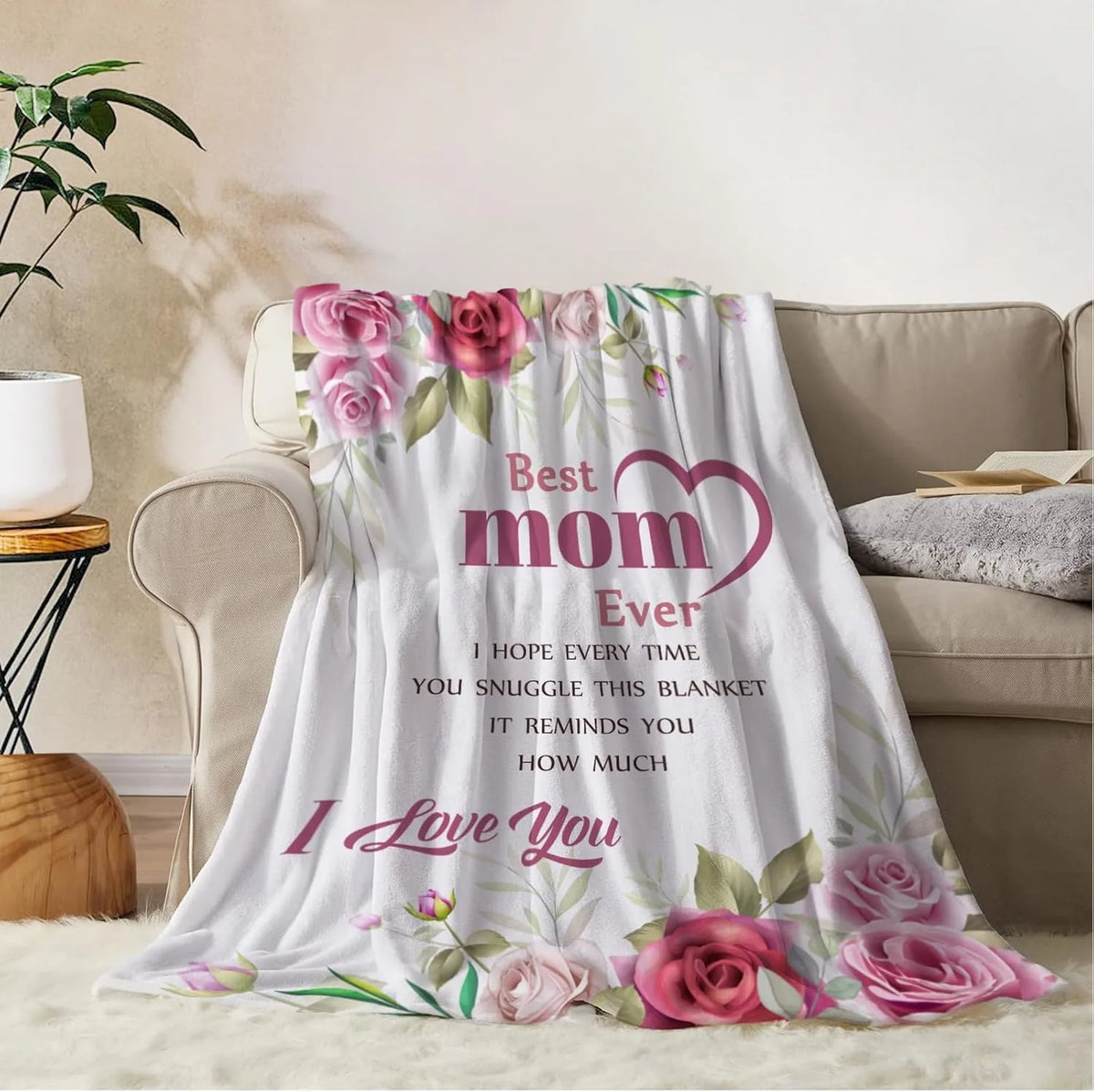 A soft pink and green floral flannel throw blanket with 'Best Mom Ever' and 'I Love You' text