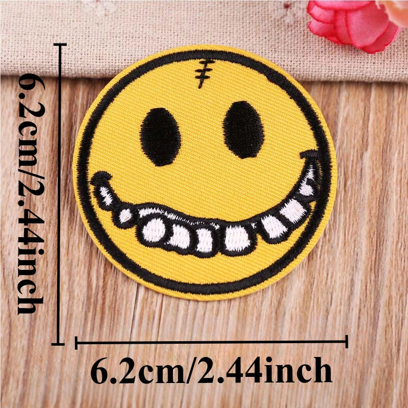 Yellow embroidered patch featuring a smiling face with sharp teeth and lightning bolt detail