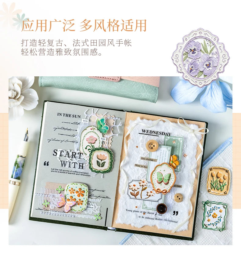 A set of vintage botanical flower stickers for journaling and scrapbooking displayed on an open notebook.