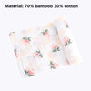 A rolled pink and white fabric, made of 70% bamboo and 30% cotton, featuring a floral pattern.