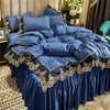 A luxurious royal blue bed skirt set featuring elegant lace edging and gathered fabric.