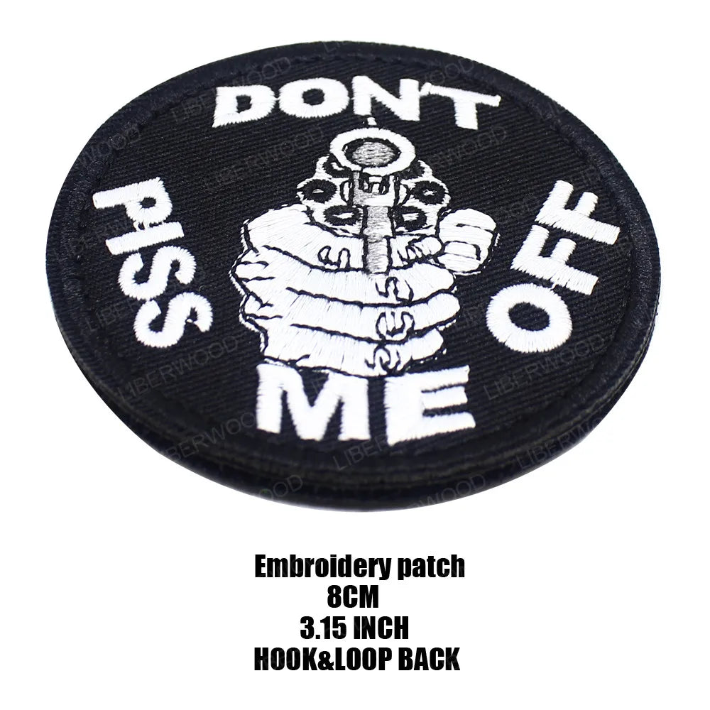 Black embroidered patch with white text saying DON'T PISS ME OFF