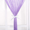 A purple thread curtain tie-back with a white ribbon tied at the top.