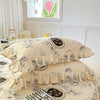 Two floral cotton pillow covers with ruffled edges on a bed