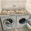 A pair of white vintage laundry appliances with wooden covers are displayed in a light-colored room.