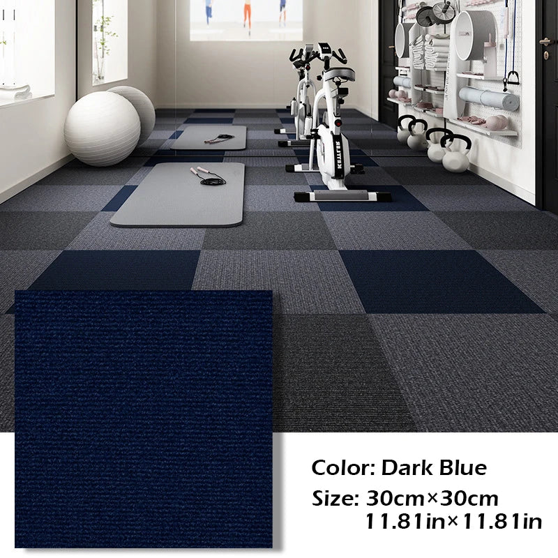 Dark blue square carpet tiles laid in a grid pattern in a modern gym or home fitness area.