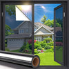 A close-up view of a one-way privacy window film installed on a glass door, showing sunlight glare reduction.