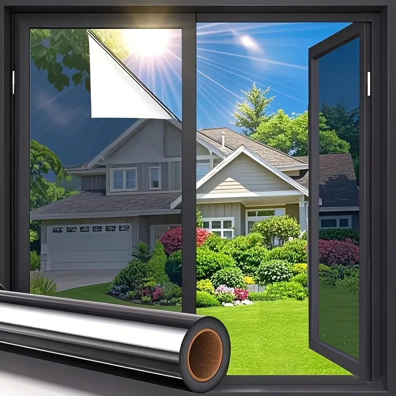 A close-up view of a one-way privacy window film installed on a glass door, showing sunlight glare reduction.