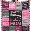 A pink and black patterned throw blanket featuring various birthday and loving messages for a mom