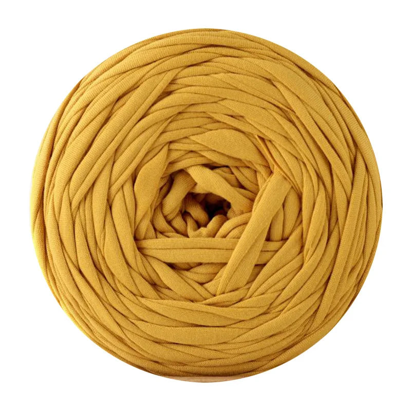 A ball of golden yellow soft T-shirt yarn used for crochet