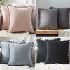 A set of luxurious velvet decorative cushion covers in shades of pink, gray, and black with beaded trim.