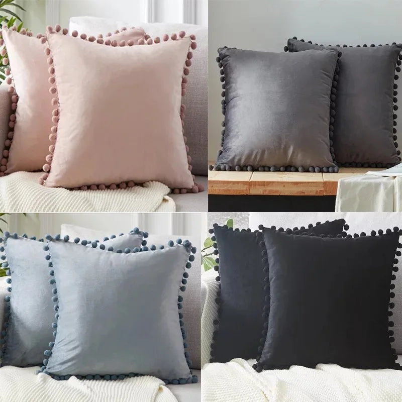 A set of luxurious velvet decorative cushion covers in shades of pink, gray, and black with beaded trim.