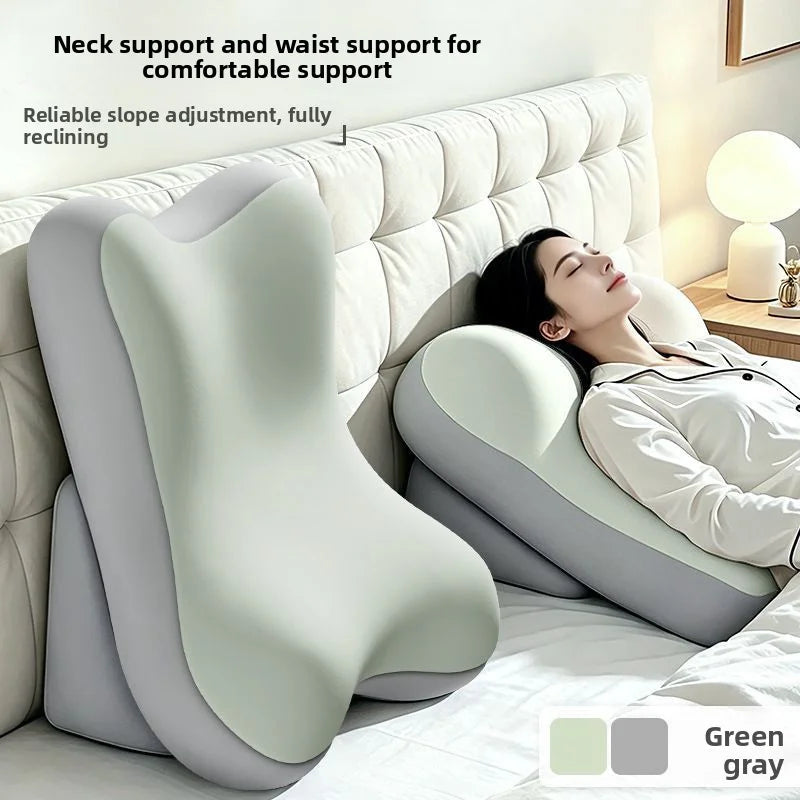 A white ergonomic memory foam lumbar pillow is shown supporting a person's neck and waist in a bed.
