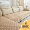 Tan quilted sofa cushion cover displayed on a beige sofa, showing its texture and washing instructions.