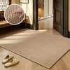 A rectangular beige faux sisal runner rug placed on a light wood floor.