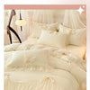 A luxurious white princess chiffon duvet cover set with ruffled details and decorative pillows.