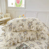 Two floral cotton pillow covers with ruffled edges on a bed