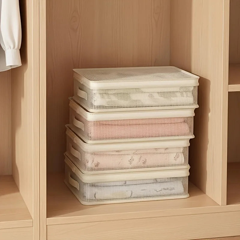 Stack of clear mesh storage bags filled with folded bed sheets and blankets inside a wooden cabinet