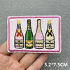 Pink embroidered slogan patches featuring bottles of wine for DIY iron-on projects
