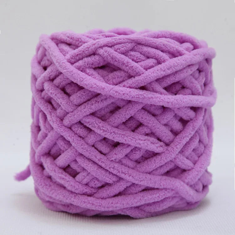 A ball of soft purple chenille knitting yarn used for hand crafting.