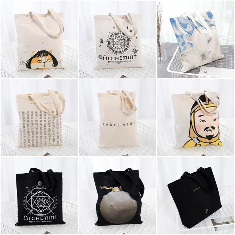 A collection of reusable canvas tote bags in various colors and designs, including black, beige, and blue patterns.