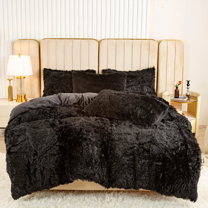 A black plush duvet cover set displayed on a bed with light beige upholstered headboards.