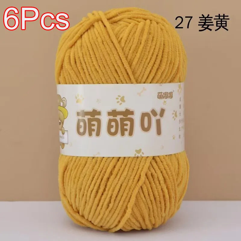 A skein of 6 pieces of yellow chenille yarn labeled as 27 strands for crochet and knitting.