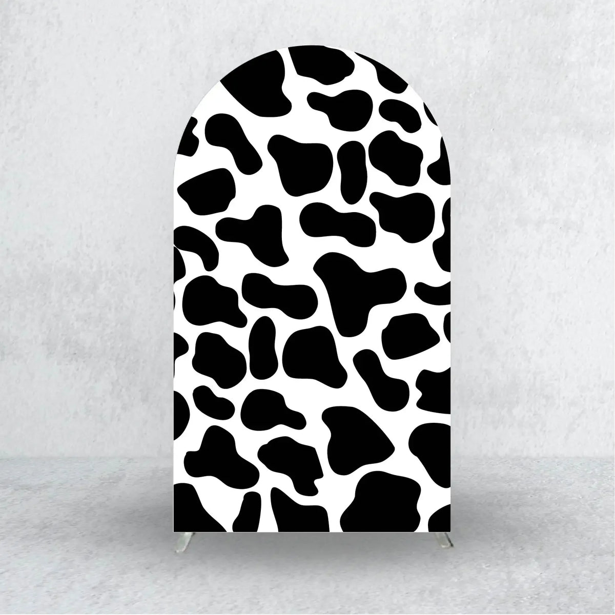A black and white abstract animal print fabric used as an elegant party arch backdrop cover.