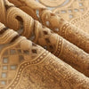 Close-up of a beige hollow perforated curtain fabric with intricate lace and embroidered detailing.