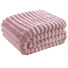 A stack of soft, mauve faux fur throw blankets folded neatly.