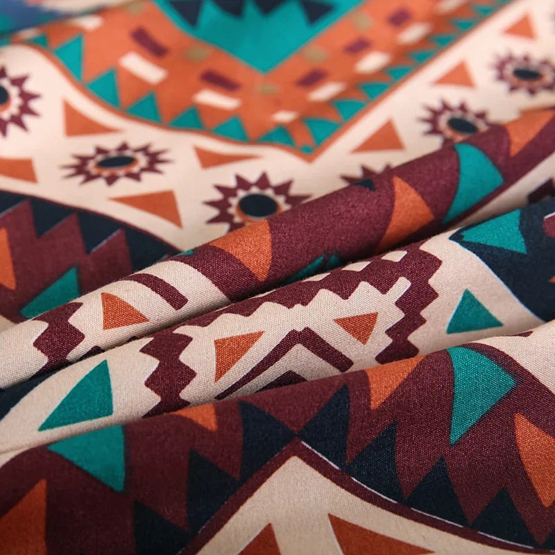Close-up of a fabric featuring an orange and teal geometric pattern used for a boho duvet cover set.